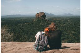 Man and Woman Cuddling Looking at Scenic View 